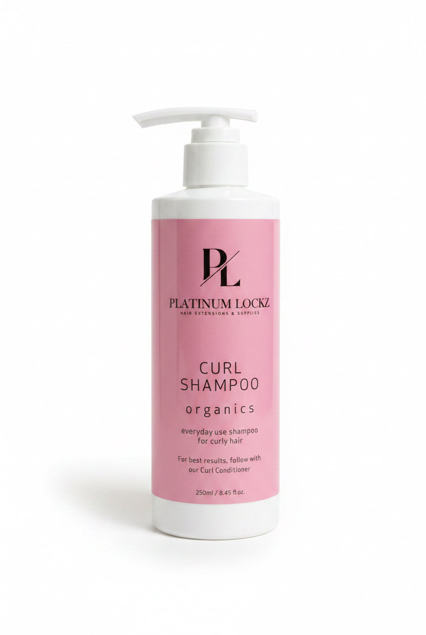 Platinum Loco Curl Shampoo bottle on a dark surface with a textured gray background