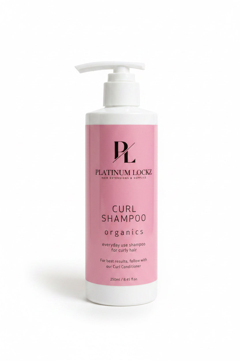 Platinum Loco Curl Shampoo bottle on a dark surface with a textured gray background